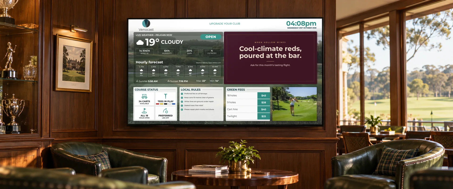 A Venocast screen on the timber wall of a clubhouse lounge bar, beside the trophy cabinet, showing the weather, local rules, green fees and a sponsor advert
