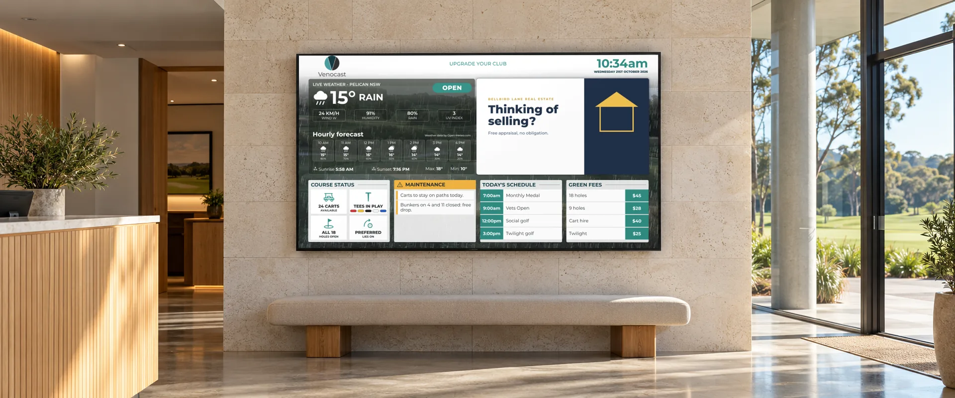 A Venocast screen on the stone wall of a club foyer above a bench, showing the rain, a maintenance notice, today’s schedule, green fees and a sponsor advert