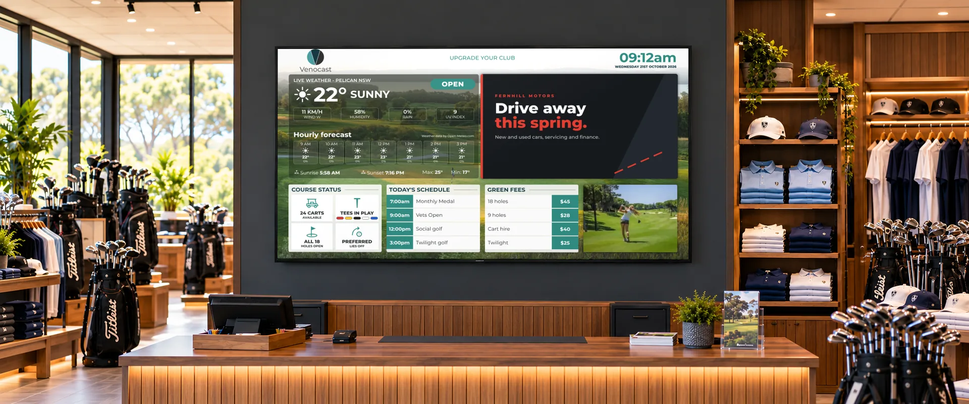 A Venocast screen behind the pro shop counter, among golf bags and shirts, showing the weather, course status, today’s schedule, green fees and a sponsor advert